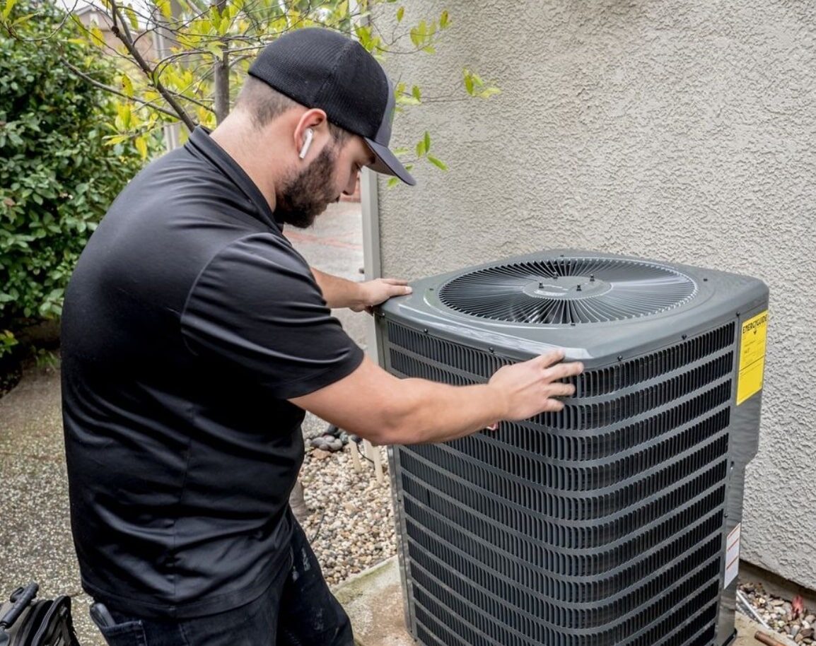 atticman tech looking at an hvac unit